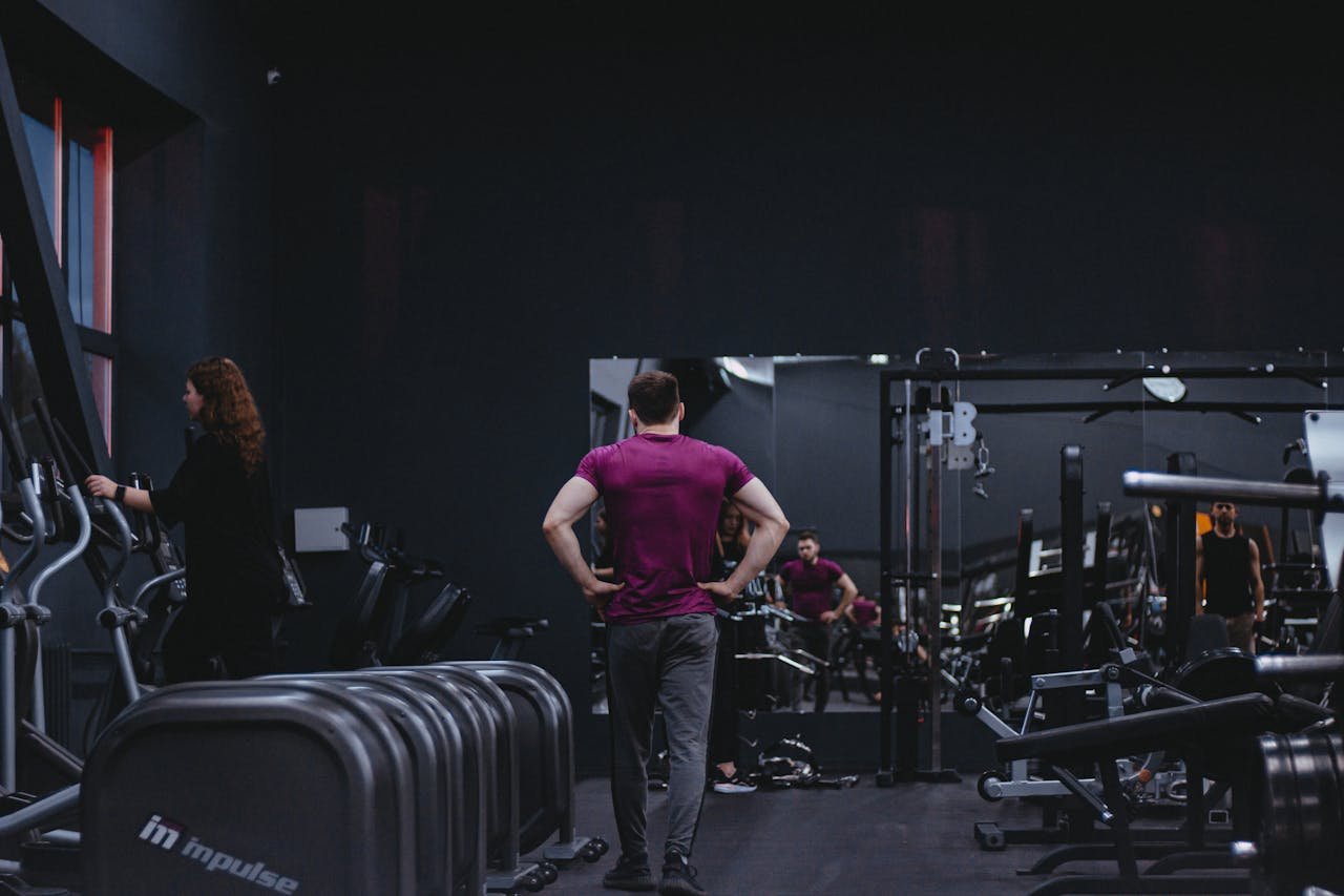 gallery-5 Man in a gym with fitness equipment, highlighting a healthy lifestyle.